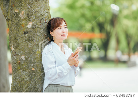 Woman holding a smartphone Woman holding a smartphone 68498787