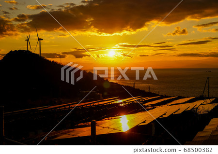 Sunset and silhouette reflecting on the sea and solar panels Sunset and silhouette reflecting on the sea and solar panels 68500382