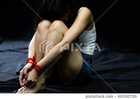 Victim women tied up with red rope 68500789
