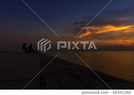 silhouette of fishermen at the lake with twilight silhouette of fishermen at the lake with twilight 68501260