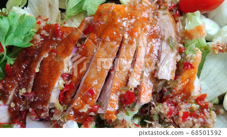 Sliced roasting Traditional Christmas Duck dressing with salad tomatoes and spicy sweet sauce at gourmet chinese restaurant, food advertisement backgrounds Sliced roasting Traditional Christmas Duck dressing with salad tomatoes and spicy sweet sauce at gourmet chinese restaurant, food advertisement backgrounds 68501592