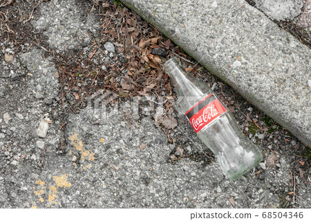 Glass bottle thrown on the ground Glass bottle thrown on the ground 68504346