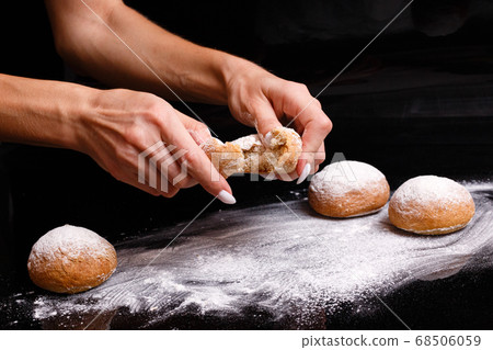 Homemade pastries. White buns are separated by hand. Photo of baking. Homemade pastries. White buns are separated by hand. Photo of baking. 68506059
