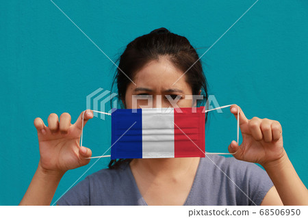 A woman with France flag on hygienic mask in her hand A woman with France flag on hygienic mask in her hand 68506950