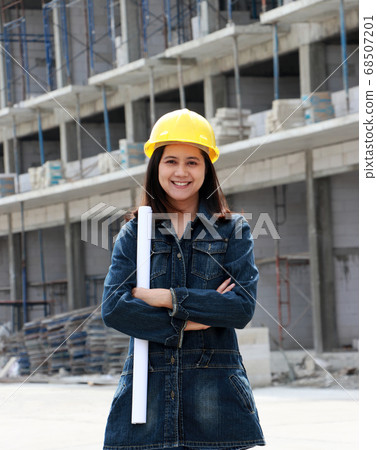 Female civil engineer or architect with yellow helmet. 68507201