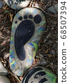 Hand-painted colorful stones. Stone painting. Human foot drawing 68507394