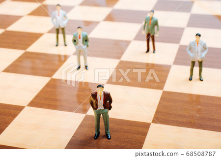 Miniature people standing on chessboard as 68508787