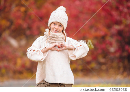 Adorable little girl at beautiful autumn day outdoors 68508988