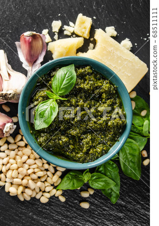Flat lay view at green bowl with genovese pesto 68511111