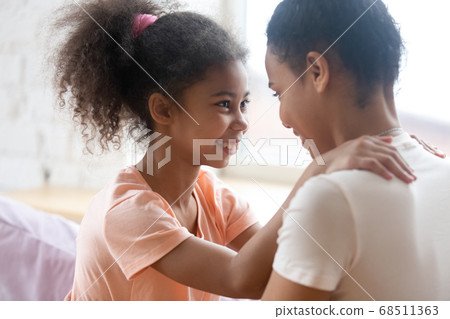Affectionate loving black mother and daughter enjoying happy moments together 68511363