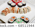 set of different types of sushi on a white plate 68511944