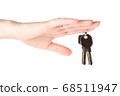 House keys in the female hand on a white background 68511947