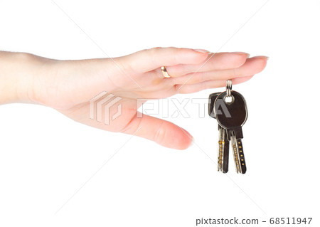 House keys in the female hand on a white background 68511947
