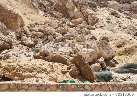 Rock collapse on the beach. Collapsed rock, Rock collapse on the beach. Collapsed rock, 68512369
