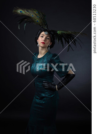 beautiful woman in retro style with feather beautiful woman in retro style with feather 68513230