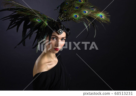 beautiful woman in retro style with feather beautiful woman in retro style with feather 68513231
