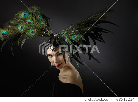 Woman in retro style with feather headdress. Woman in retro style with feather headdress. 68513234