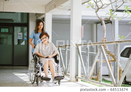 Senior woman in wheelchair Smiling female physiotherapist Senior woman in wheelchair Smiling female physiotherapist 68513874