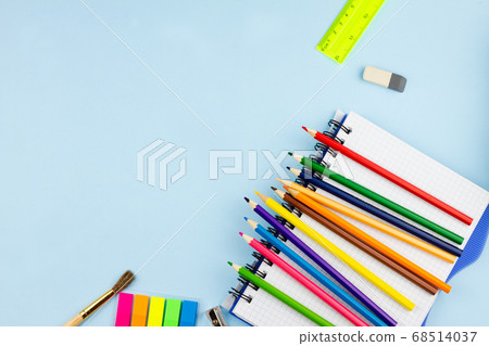 Pencils lie on a notebook on a blue background. 68514037
