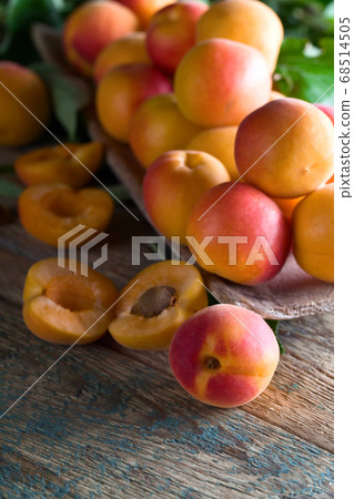 Juicy fresh apricots with leaves on old wooden 68514505