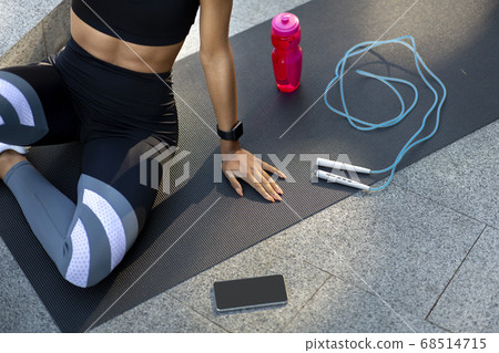 Sporty girl resting on fitness map, training outdoor Sporty girl resting on fitness map, training outdoor 68514715