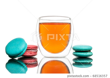 Tea cup French Colorful macaroons cookies on white Tea cup French Colorful macaroons cookies on white 68516357