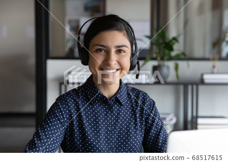 Head shot smiling young indian ethnicity woman in headphones. 68517615