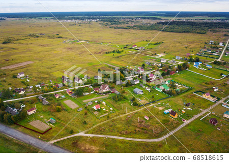 Country village in field near forest 68518615