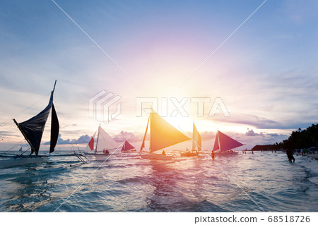 Sailing boats floating in tropical sea. Sunset 68518726