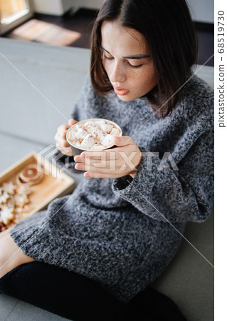 Warming hygge mood. Woman enjoy hot chocolate Warming hygge mood. Woman enjoy hot chocolate 68519730
