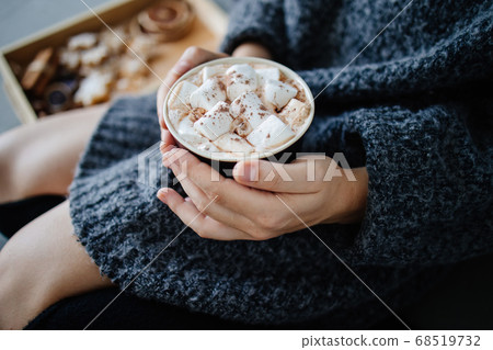 Warming hygge mood. Woman drinking hot chocolate Warming hygge mood. Woman drinking hot chocolate 68519732