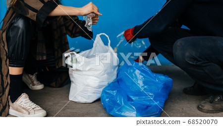 Two perrson sorting garbage. Concept of recycling. Zero waste Two perrson sorting garbage. Concept of recycling. Zero waste 68520070