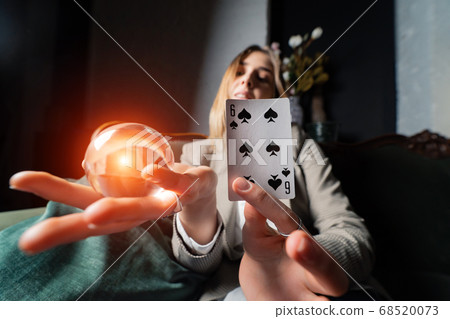 Woman in business suit holding crystal ball and six spade Woman in business suit holding crystal ball and six spade 68520073