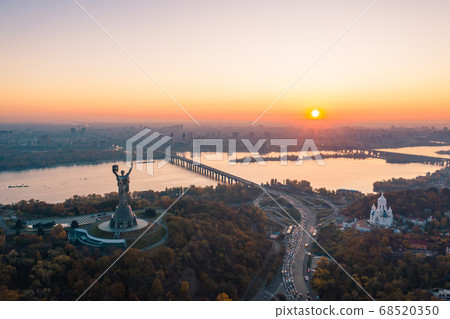 Kiev skyline over beautiful fiery sunset, Ukraine. Monument motherland. 68520350