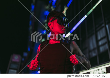 Cyberpunk style. Tattooed guy in one city. Cyber glasses. Cyberpunk style. Tattooed guy in one city. Cyber glasses. 68521070