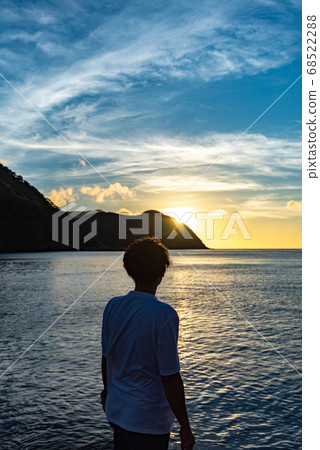 Man twilight with the setting sun Man twilight with the setting sun 68522288