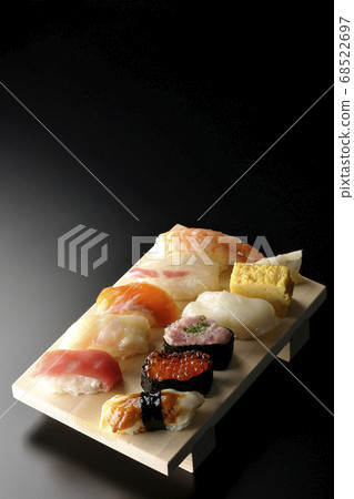 Tuna, scallop, salmon, salmon roe, shrimp, sea bream, squid, conger eel, nigiri sushi rolled on sushi geta (black background) Tuna, scallop, salmon, salmon roe, shrimp, sea bream, squid, conger eel, nigiri sushi rolled on sushi geta (black background) 68522697