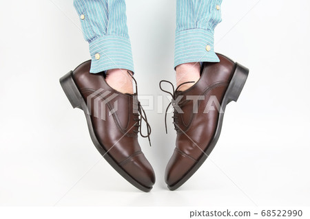 Classic brown shoes worn on the hands Classic brown shoes worn on the hands 68522990
