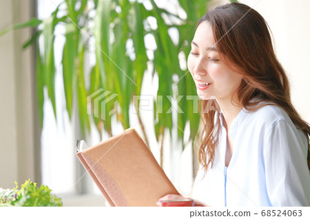 Woman reading a book and feeling kind 68524063