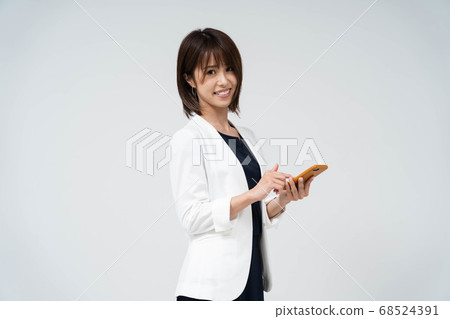 Woman using a smartphone Woman using a smartphone 68524391