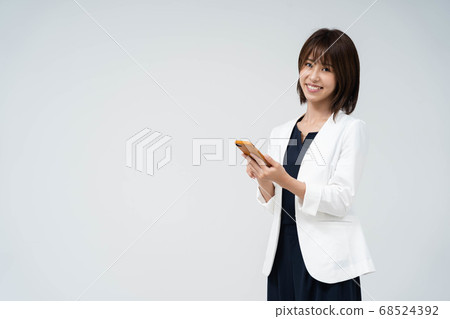 Woman using a smartphone Woman using a smartphone 68524392
