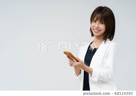 Woman using a smartphone Woman using a smartphone 68524393