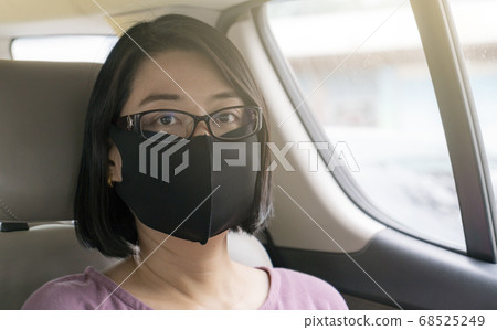 Portrait of Asian woman passenger in taxi Portrait of Asian woman passenger in taxi 68525249