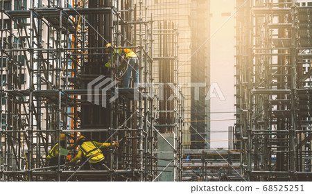 Asian construction workers installing concrete Asian construction workers installing concrete 68525251