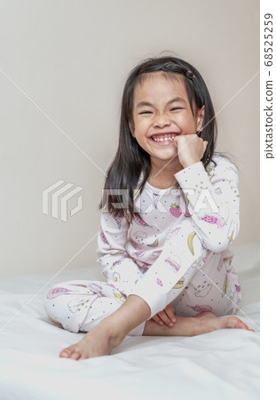 Happy and healthy Asian child girl sitting on Happy and healthy Asian child girl sitting on 68525259