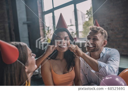Friends greeting a woman during the birthday party Friends greeting a woman during the birthday party 68525691