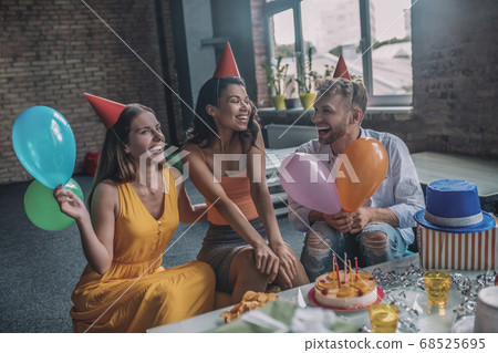 Relaxed friends enjoying a birthday party together 68525695