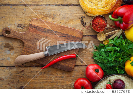 Fresh vegetables and healthy ingredients, knife on cutting board Fresh vegetables and healthy ingredients, knife on cutting board 68527678