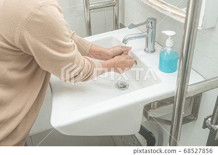 Asian washing hand by liquid soap and clean water 68527856