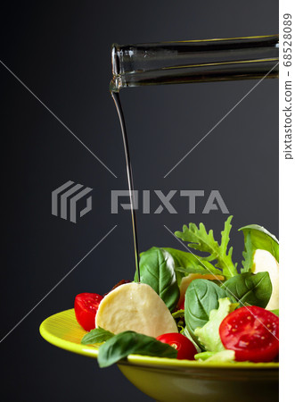 Green salad with mozzarella, tomato, basil and Green salad with mozzarella, tomato, basil and 68528089